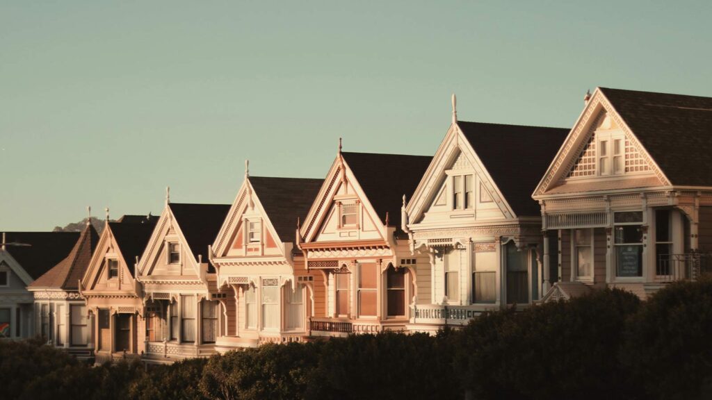 a row of houses with trees in the background that highlights Abstract Title