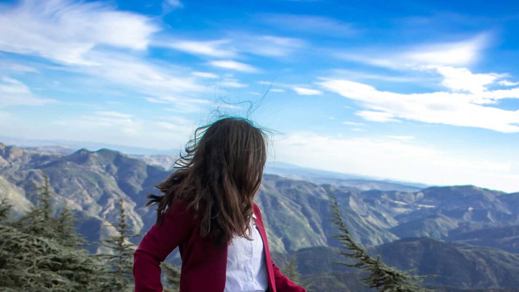 a woman standing on a mountain and image to support easements and rights-of-way