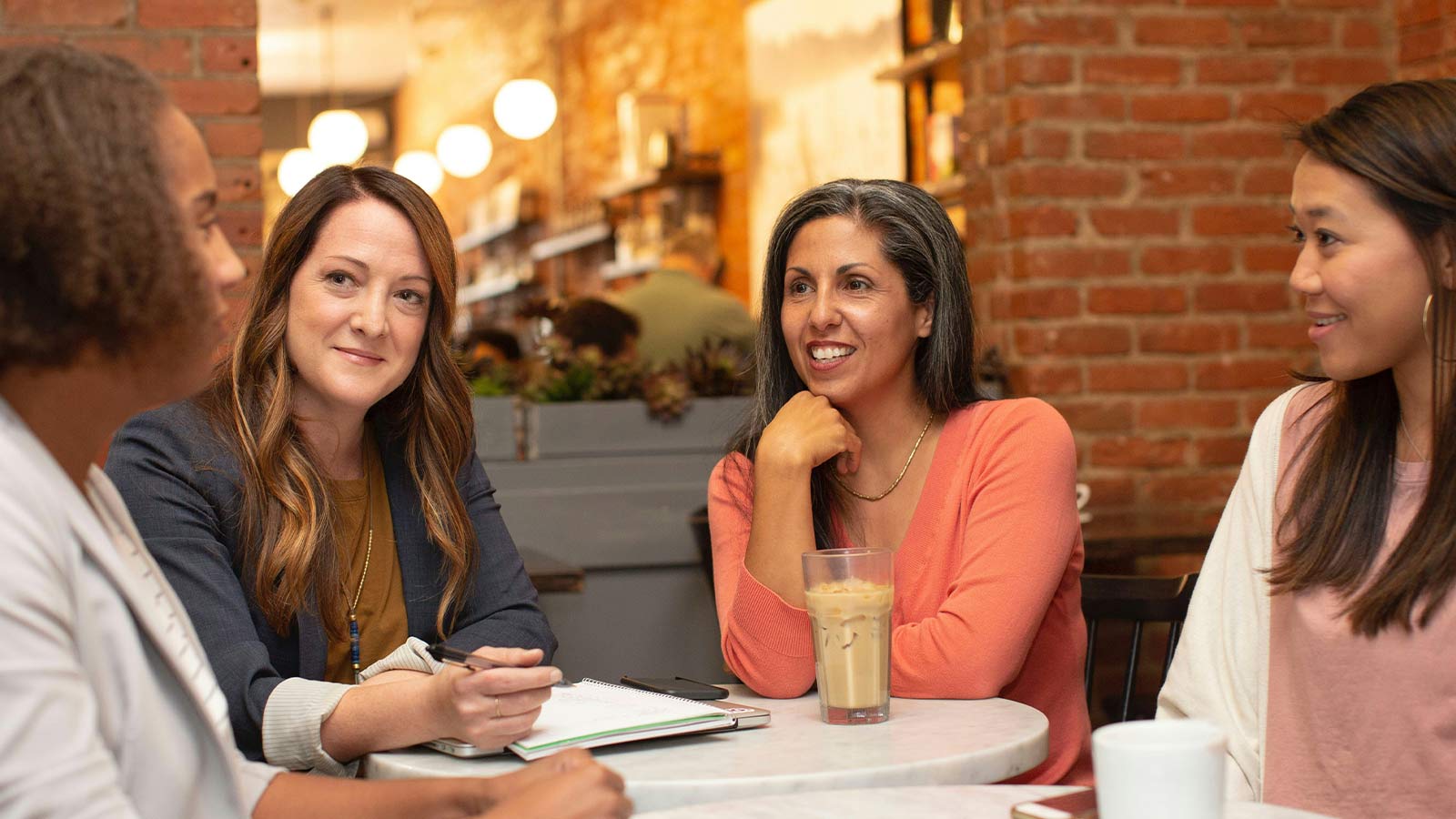a group of women sitting at a table discussing Home Title, deeds in florida