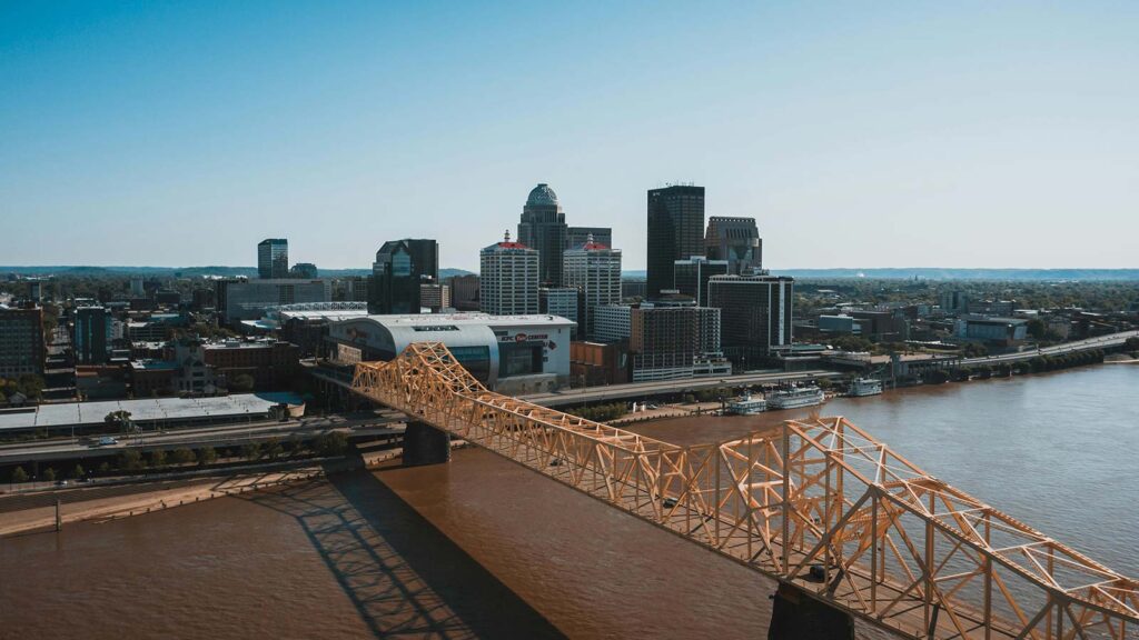 a bridge over a river with a city in the background Kentucky Title Search