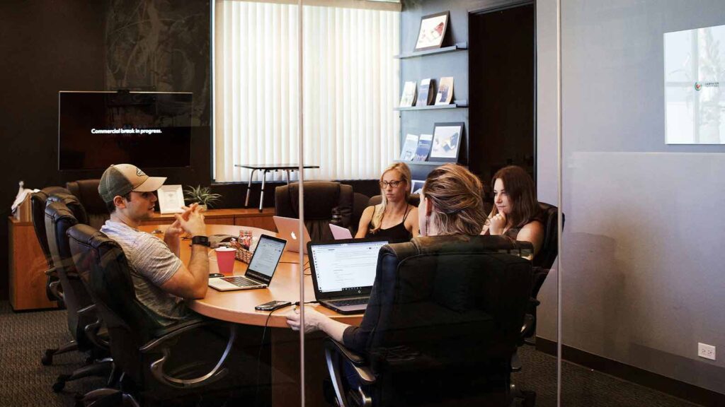 office people sitting around talking about title search